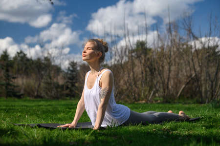 Yoga practice and meditation outdoor. Girl in the parkの写真素材