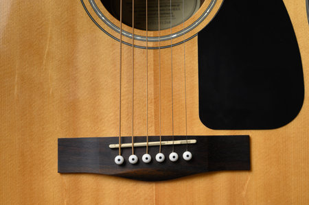 Man playing acoustic guitar, cover for online courses, learning at home.