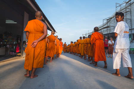 Young buddhists in orange clothes near the Big Buddha Temple in Phuket in Thailand. April 28, 2019のeditorial素材