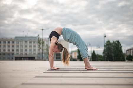 Girl practice yoga and meditation in the city.