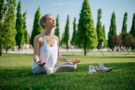Yoga practice and meditation outdoor. Girl in the parkの写真素材