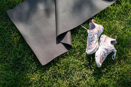 Yoga mat outdoor on green grass in parkの写真素材