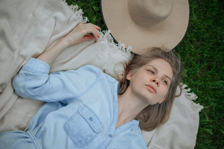 Romantic girl with hat on picnic in park