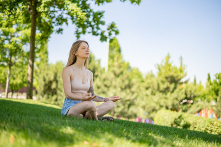 Girl practice yoga meditation outdoor in park