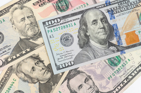 5, 20, 50, 100 dollars banknotes at different angles. Close up of dollars on white background.の写真素材