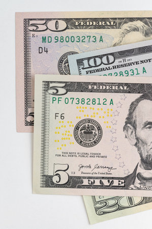 5, 20, 50, 100 dollars banknotes at different angles. Close up of dollars on white background.