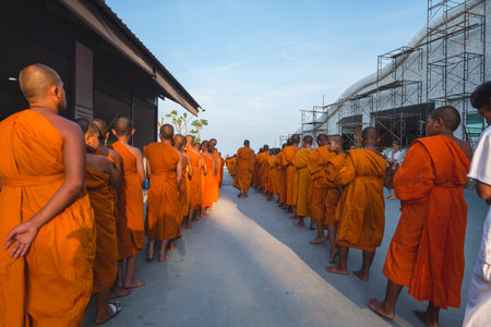 Young buddhists in orange clothes near the Big Buddha Temple in Phuket in Thailand. April 28, 2019のeditorial素材