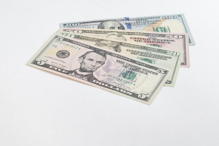 5, 20, 50, 100 dollars banknotes at different angles. Close up of dollars on white background.