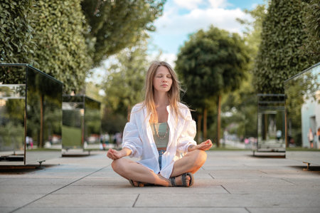 Girl practice yoga meditation outdoor in park