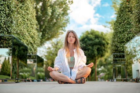 Girl practice yoga meditation outdoor in parkの写真素材