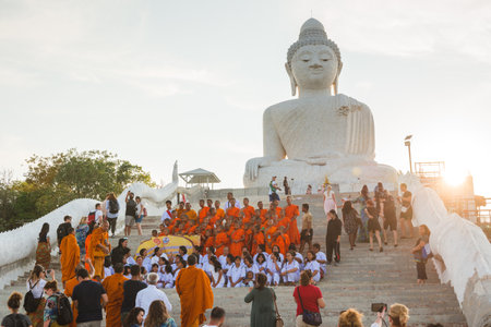 Young buddhists in orange clothes near the Big Buddha Temple in Phuket in Thailand. April 28, 2019のeditorial素材