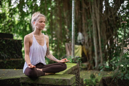 Girl practice yoga meditation outdoor in park