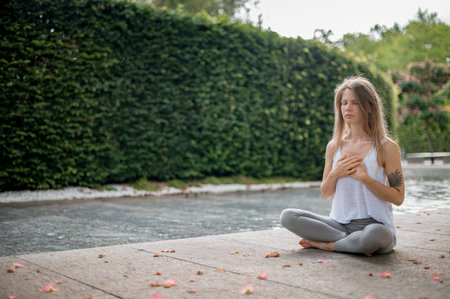 Girl practice yoga meditation outdoor in parkの写真素材