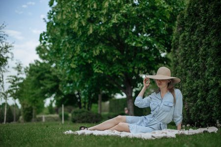 Romantic girl with hat on picnic in parkの写真素材
