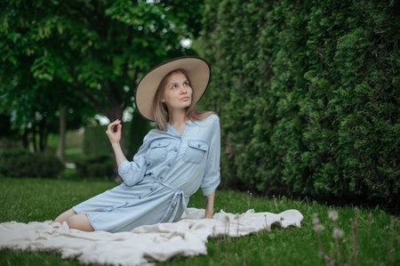 Romantic girl with hat on picnic in parkの写真素材