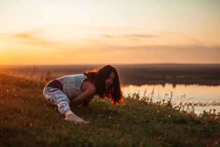 Yoga practice and meditation outdoor. Girl in the parkの写真素材
