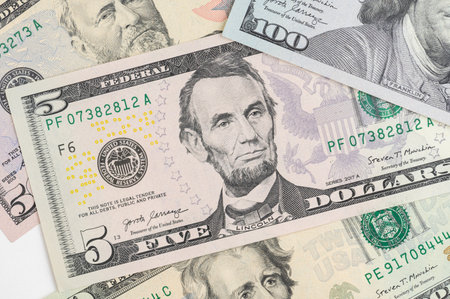 5, 20, 50, 100 dollars banknotes at different angles. Close up of dollars on white background.の写真素材
