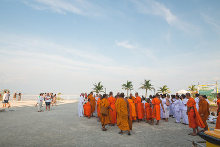 Young buddhists in orange clothes near the Big Buddha Temple in Phuket in Thailand. April 28, 2019.のeditorial素材