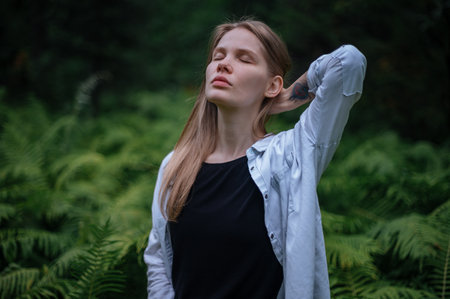 Girl in green forest. Practice of meditation and interaction with natureの写真素材