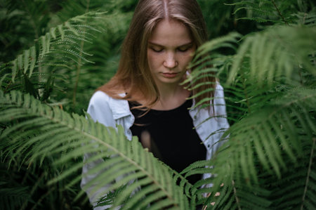 Girl in green forest. Practice of meditation and interaction with natureの写真素材