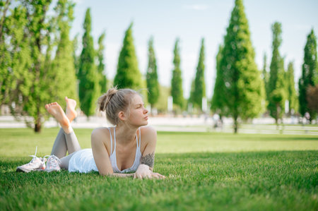 Beautiful girl practice yoga outdoor. Meditation in parkの写真素材