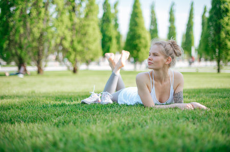 Beautiful girl practice yoga outdoor. Meditation in parkの写真素材