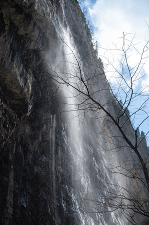 Mountain waterfall in Abkhazia. The wind blows away the pressure of the waterの写真素材