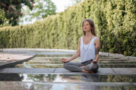 Girl practice yoga meditation outdoor in parkの写真素材