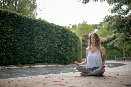 Girl practice yoga meditation outdoor in parkの写真素材
