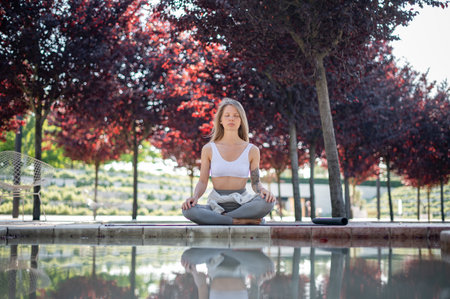 Girl practice yoga meditation outdoor in parkの写真素材