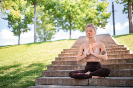 Girl practice yoga meditation outdoor in parkの写真素材