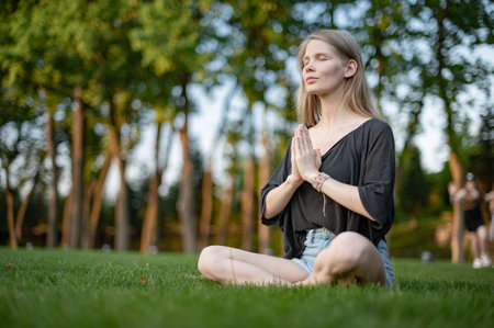 Girl practice yoga meditation outdoor in parkの写真素材