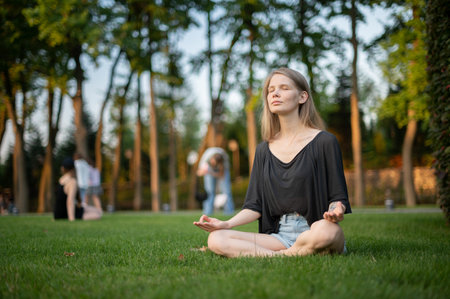 Girl practice yoga meditation outdoor in parkの写真素材
