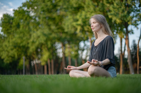 Girl practice yoga meditation outdoor in parkの写真素材