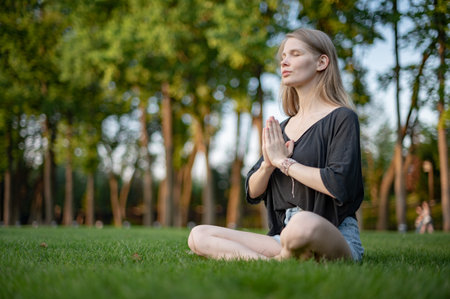 Girl practice yoga meditation outdoor in parkの写真素材