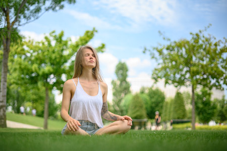 Girl practice yoga meditation outdoor in parkの写真素材