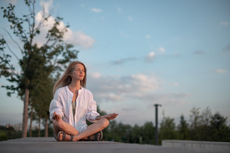 Girl practice yoga meditation outdoor in parkの写真素材