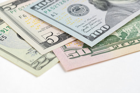 5, 20, 50, 100 dollars banknotes at different angles. Close up of dollars on white background.の写真素材