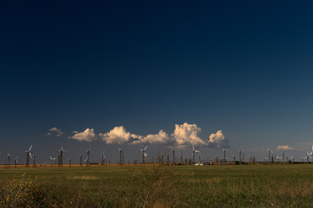Wind Turbines Windmill Energy Farm on green field and blue skyの写真素材