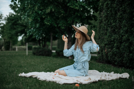 Romantic girl with hat on picnic in parkの写真素材