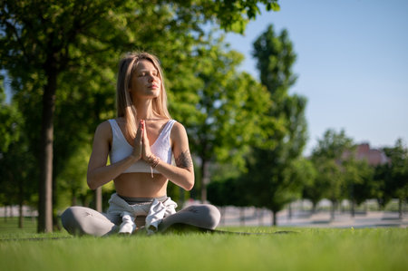 Girl practice yoga meditation outdoor in parkの写真素材