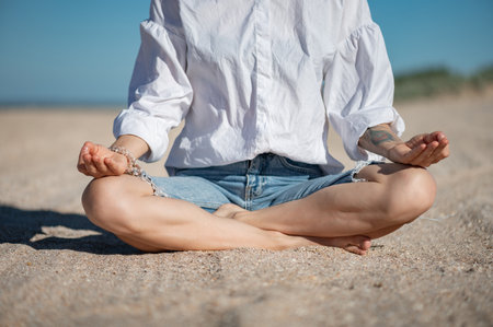 Girl practice meditation on the beach. With space for text or designの写真素材