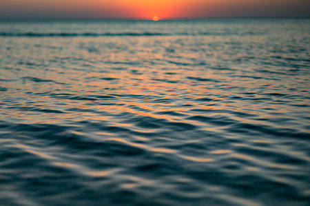 Close up of sea surface on sunset. Water backgroundの写真素材