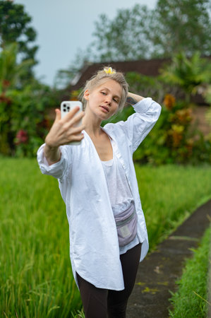 Girl make a selfie outdoor in green rice terraceの写真素材