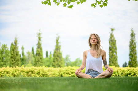 Girl practice yoga meditation outdoor in parkの写真素材