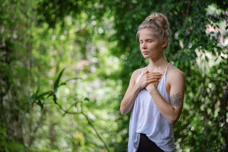 Girl practice yoga meditation outdoor in parkの写真素材