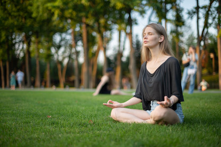 Girl practice yoga meditation outdoor in parkの写真素材