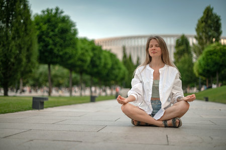 Young girl practice meditation in the parkの写真素材