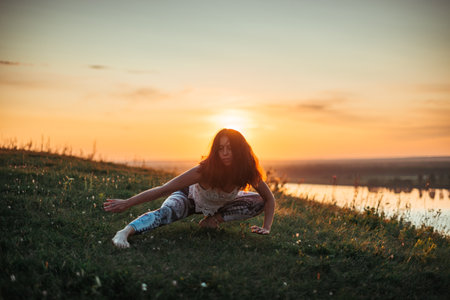 Yoga practice and meditation outdoor. Girl in the parkの写真素材
