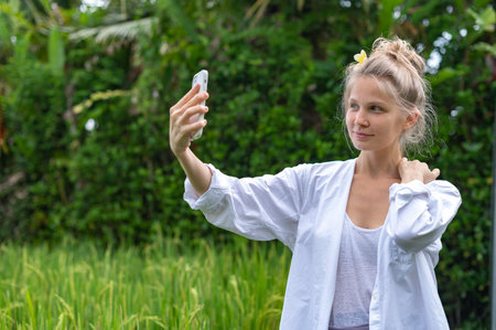 Girl make a selfie outdoor in green rice terraceの写真素材